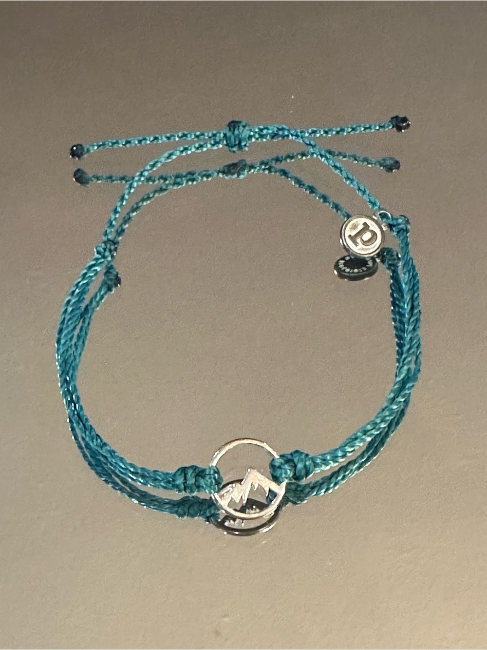 Pura Vida. Teal Braided Bracelet with Mountain Charm